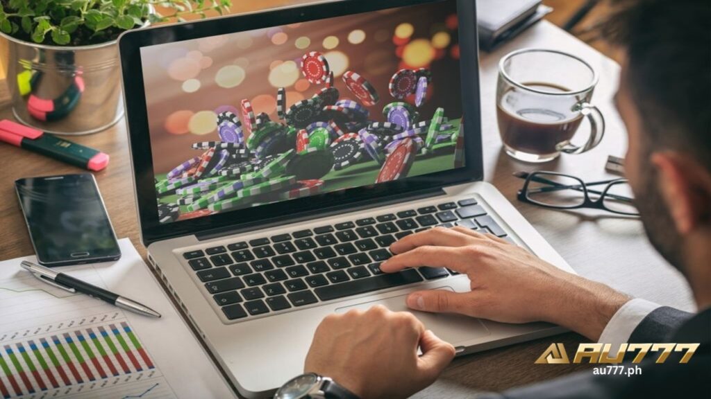 a man infront of laptop that displays online casino chips